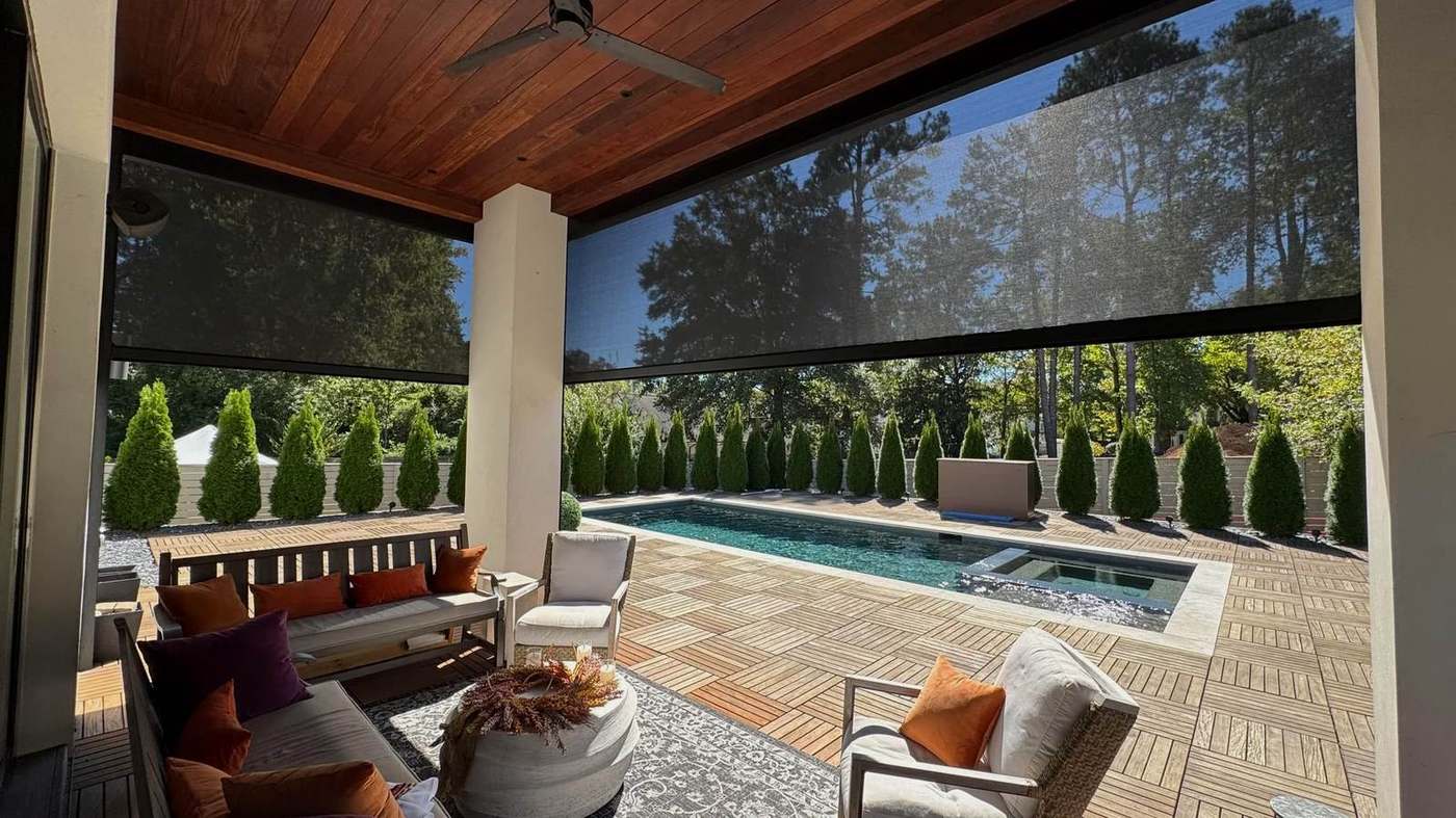 Retractable screen installation around a poolside outdoor room